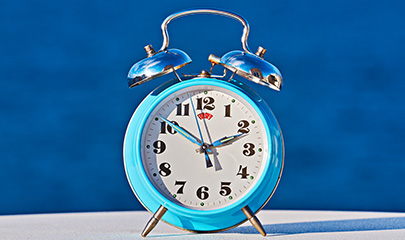 blue-alarm-clock-against-sea-background-as-spring-2025-01-08-17-33-52-utc