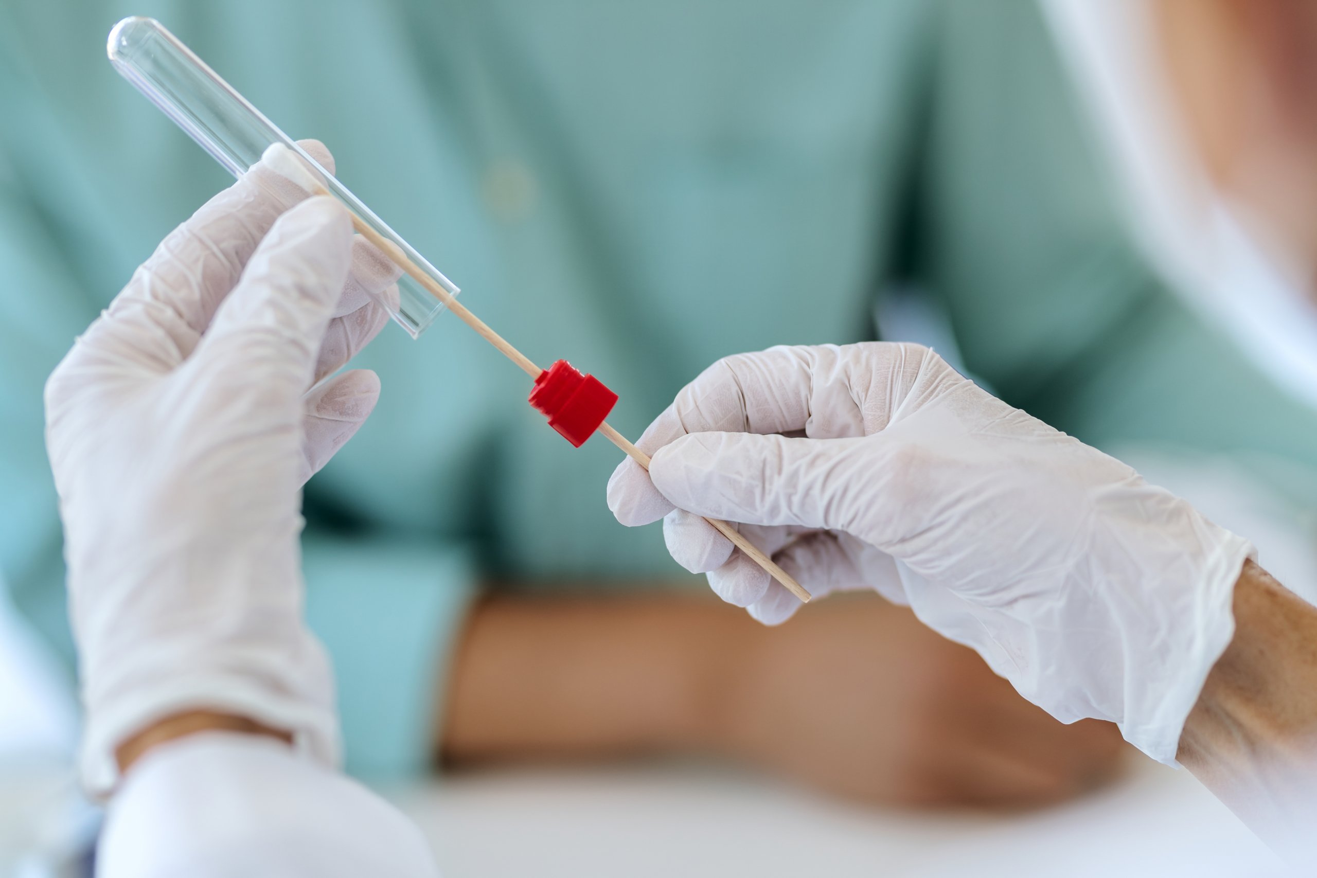 Close-up of doctor doing PCR test during COVID-19 pandemic.