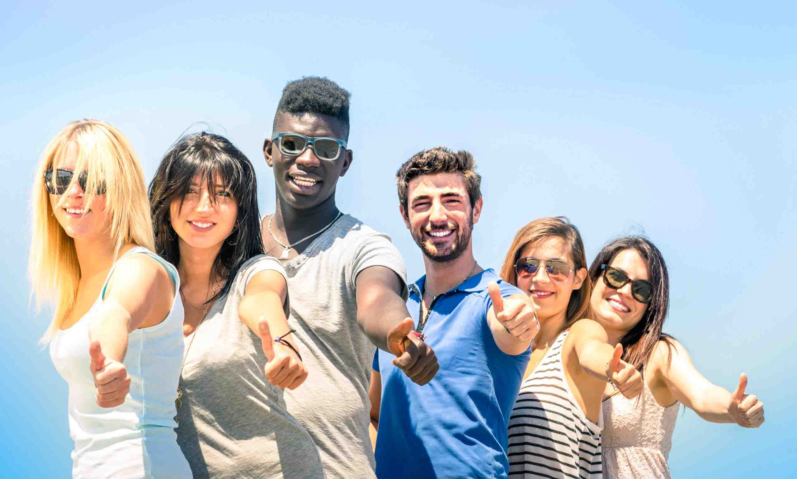 group-of-multiracial-happy-friends-with-thumbs-up-2024-07-03-02-44-02-utc-scaled